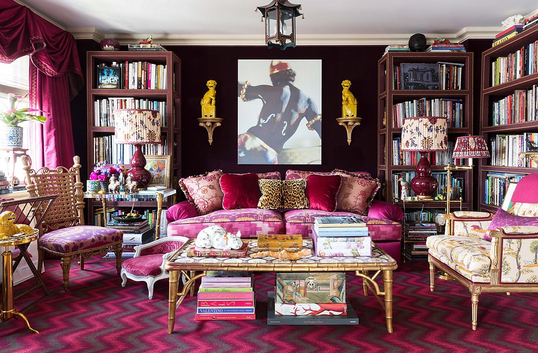 Rich textiles create a cocoonlike feel in the library. Deep purple velvet lines the walls, and the étagères feature a fabric overlay. The chevron carpet is one of Alex’s own designs for Langhorne.
